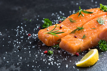 Salmon fish fillets on dark marble table