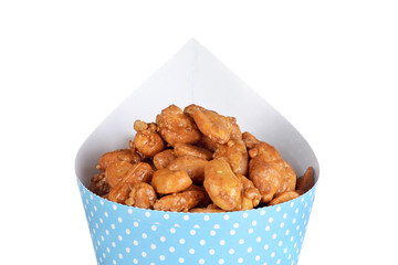 isolated closeup honey covered peanuts in a blue cone