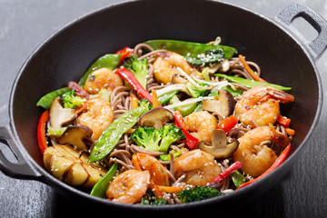 Stir fried noodles with shrimps and vegetables in a wok - obrazy, fototapety, plakaty