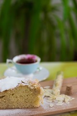 pieces of German butter cake with almonds on the wooden table