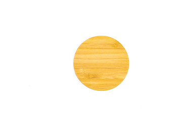 Top view of wooden round serving dish plate on the table