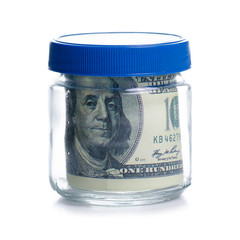 Money dollars bank notes in glass jar isolated on white background, concept save money