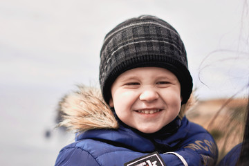 Little boy with a young beauty mom walking outdoors