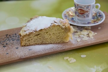 pieces of German butter cake with almonds on the wooden table