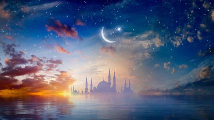 Ramadan Kareem religious background with mosque silhouettes reflected in serene sea