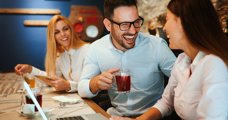 Happy colleagues from work socializing in restaurant