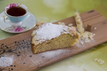 pieces of German butter cake with almonds on the wooden table
