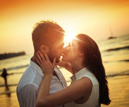 Romantic couple kissing on a hot, tropical beach