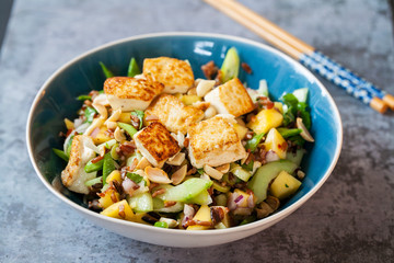 Vegan salad with crispy tofu, red and wild rice and mango