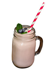 Blueberry milk shake in glass with straw on white background