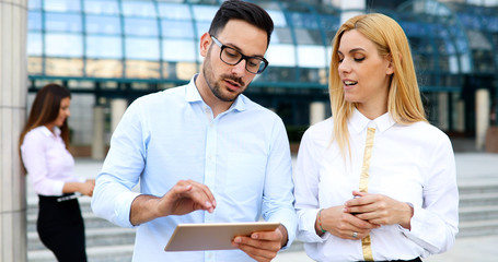 Picture of young attractive business partners standing