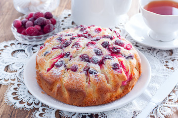 Homemade pie with cranberries and apples on a white napkin, horizontal