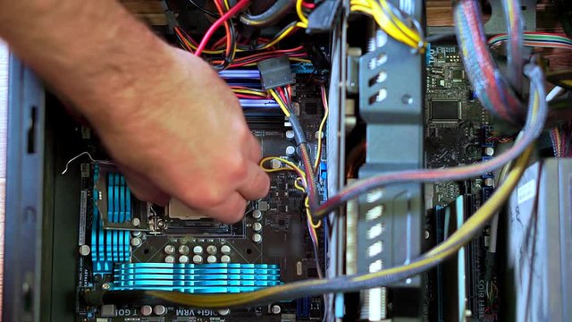 Close-up of male hand installing new CPU. Personal computer repair