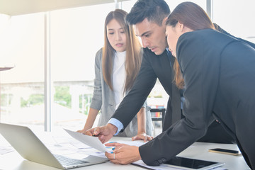 Financial report analysis and reviewing concept :CFO or chief financial officer sees financial summary reports with his secretary team and discusses about future growth and improvements