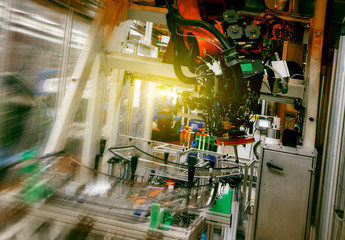 In the automotive production line, the automated robotic arm for automotive glass coating is working.