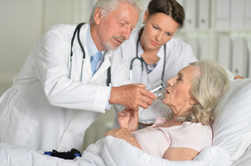 Portrait of two professional doctors inspecting patient