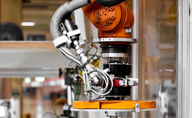 In the automotive production line, the automated robotic arm for automotive glass coating is working.