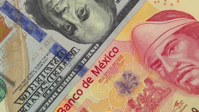Mexico peso vs US dollar bill rotating. Mexico and USA relations. 4K stock video footage