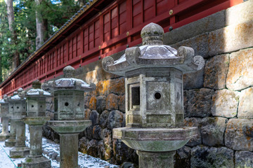 Fototapeta na wymiar Stone Lantern Pillars of Nikko Futarasan Jinja in Winter Shinto Shrine in Tochigi, Japan