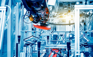 In the automotive production line, the automated robotic arm for automotive glass coating is working.