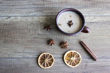 Traditional indian drink - masala tea with spices on wooden background