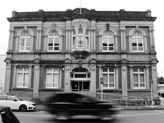 Car motion blur in front of a building