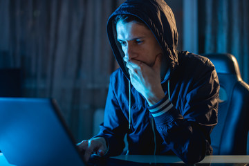 Male hacker thinking about the problem of hacking and stealing access databases with passwords....