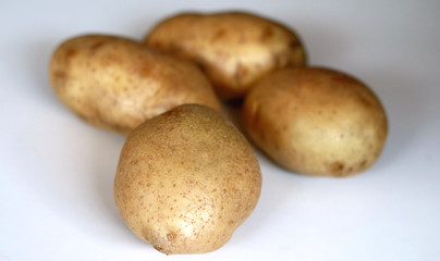 Yellow potatoes on white background.