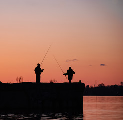 Fishing on the sunset in the city