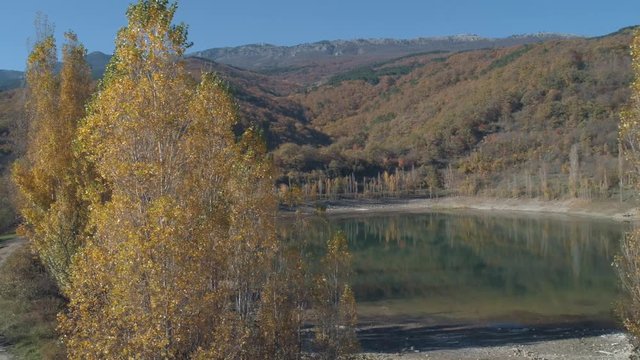 Beautiful views of lake near the mountains and trees. Shot. Amazing autumn landscape