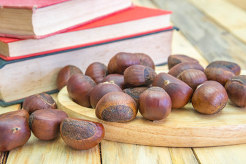 Fototapeta premium Delicious roasted chestnuts on wood background