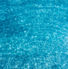 Blue water and small wave in the pool as for summer background.