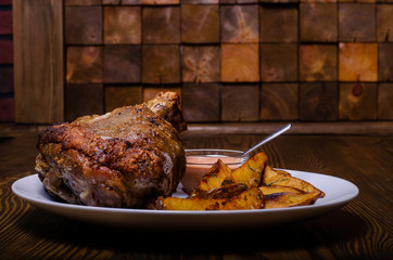 Grilled meat with fried potatoes and vegetable salad.