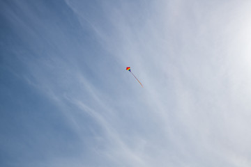 Fototapeta na wymiar Flying a kite on the giant sand dunes of Jockey's Ridge State Park in the outer banks of North Carolina