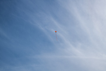 Fototapeta na wymiar Flying a kite on the giant sand dunes of Jockey's Ridge State Park in the outer banks of North Carolina