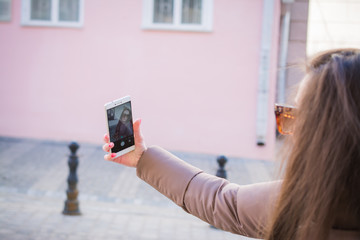 Pretty girl with long hair takes a selfie