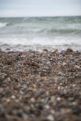 View of the baltic sea and stone beach, stormy sea waves 