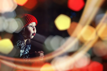 Little girl in red hat waiting for santa