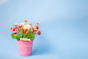 Artificial flower bouquet In pink pots and blue backgrounds