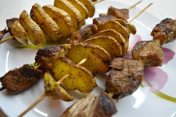potato skewers skewers sliced potatoes fried potatoes meat pork skewers