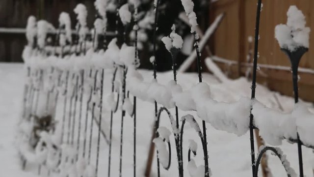 snow covering a garden fence, abstract close up video