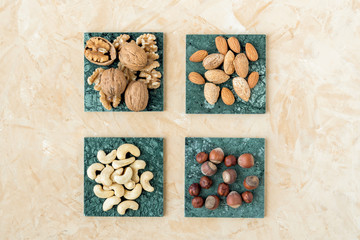 Nuts hazelnut , almond, walnut , cashew on green marble surfaces. Top view 