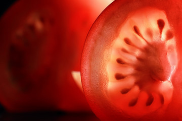 Red tomato cut in half with the texture of seeds
