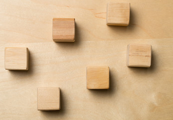 Wooden cube blocks on brown wood background
