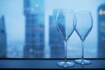 Cocktail glasses on the windowsill by the glass