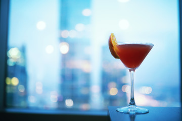 Cocktail glasses on the windowsill by the glass