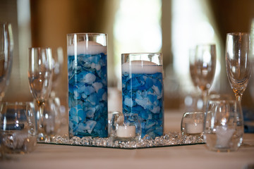 Floating candle centerpiece with blue flower pedals