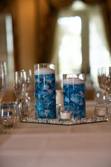 Floating candle centerpiece with blue flower pedals