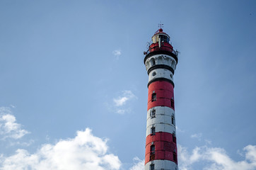 lighthouse on background of blue sky