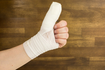 injured thumb wrapped with bandage